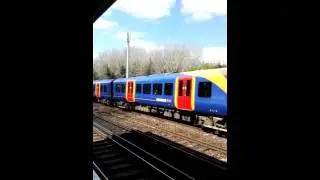 South western train service passing Raynes Park station South West London, United Kingdom