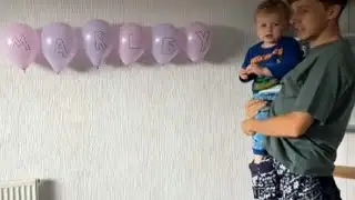 Toddler knocks down balloon display during baby name reveal event || WooGlobe