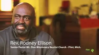 Parking Lot Preaching - Flint pastor steps outside of church walls to bring the word to members