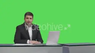 Media Broadcaster Sitting at Table on Green Screen | Stock Footage - Videohive
