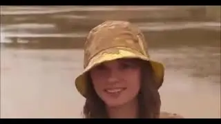 Girl wearing yellow rainwear in mud