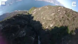 Video Incredible moment skydivers soars down mountain in just wingsuit