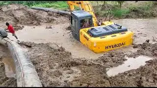 Excavator working in mud and water