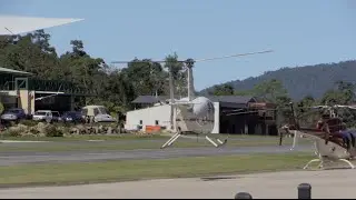 ROBINSON R44 LANDING AT AIRPORT IN WIND