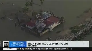 High surf floods Seal Beach restaurant parking lot