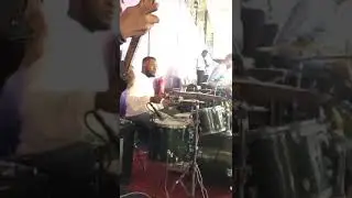 Prinx Emmanuel playing drumz in a church service