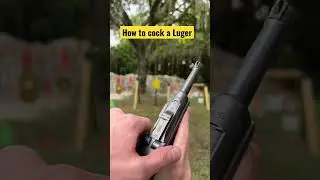 How do you cock a Luger pistol?