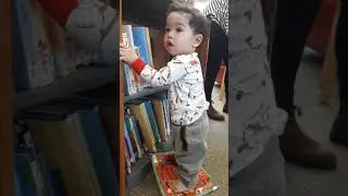 Baby Justin crawled around the library and picked the book he liked