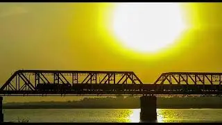 TRAIN CROSSING SILVER JUBILEE BRIDGE IN GOLDEN SUNLIGHT