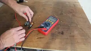 Testing AA and AAA batteries for voltage and charge with multimeter