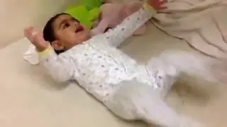 Little baby laugh funny play with pillow