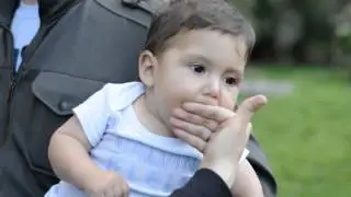 Funny baby playing with his mouth.