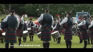 Closkelt Pipe Band runs into a shower at the 2024 British Pipe Band Championships in Forres