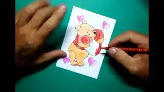Drawing Winnie the Pooh with a big heart shaped pillow