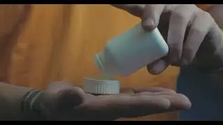 man pours pills in his hand | 4K Footage