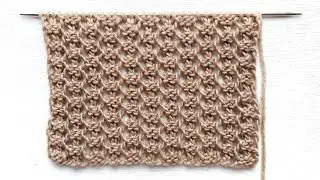 Small openwork pattern with knitting needles for knitting a jumper, cardigan