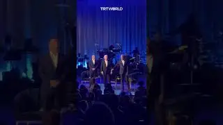Obama takes Biden’s arm and leads him off stage