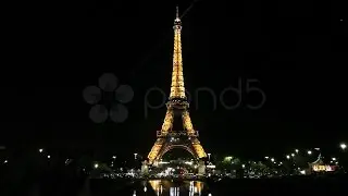 Eiffel Tower With Sparkling Stars Reflecting Off Water. Stock Footage