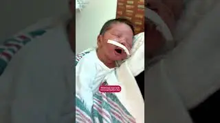 Issac smiles when his mom kisses him