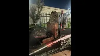 Wide version: White car runs STOP 🛑 SIGN and rams into closing exit gate.