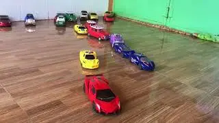 Video about model cars moving ahead and being paused by hands 