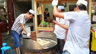 Preparing Chinese peanut snack in a food street market, Xi'an China
