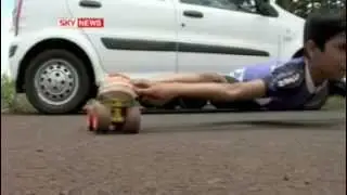 Kid skating under car