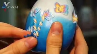 A carved candle in the shape of an egg 