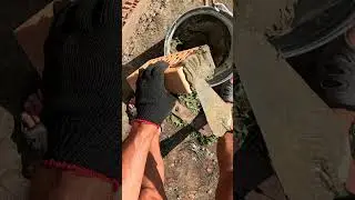 Brick facing under a round rod.