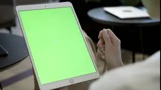 woman holding a tablet with a green screen