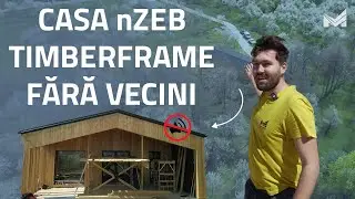 O casă TIMBERFRAME cu fațadă din lemn înconjurată de natură