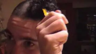 a stupid person setting fire to his hair