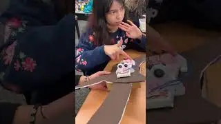 Student making music with their laser harp