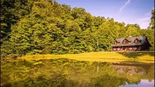 Almost Heaven! Log home on 212 Acres w/ stocked pond & barns