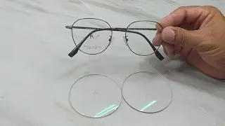Silver metal frame glasses, facet lenses.