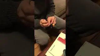 Drunk brother trying to make a xmas ornament for our mother-in-law out of a broken Trump keychain.