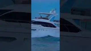Yacht goes right into the sunset sky at the Haulover inlet in Miami, Florida