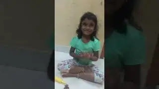 Aesha making doll in clay