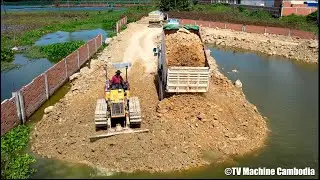 SO smart skills driver mini bulldozer pushing with truck load of stone making new road in water