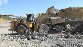 Caterpillar 990 H loading Caterpillar 775F