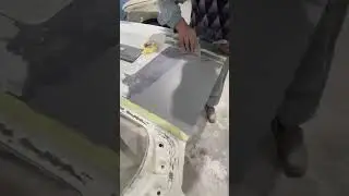 Applying gray putty on door nicely 