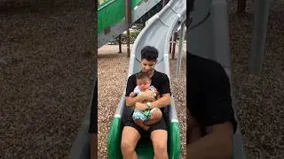 son goes down the slide with baby brother #shorts