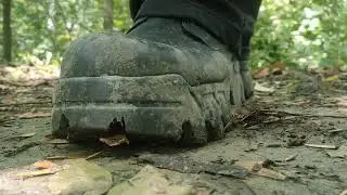 platform boots with deep lugged soles crushing some snail shells