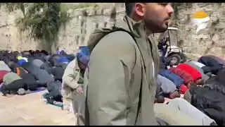 New | Palestinian worshippers perform the Friday prayer outside the gates of Al-Aqsa Mosque