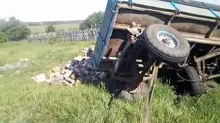 A T-40 on combine wheels flipped a loaded trailer onto its side.