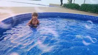 Little girl swimming in pool