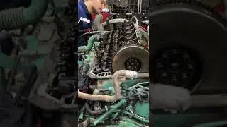 Volvo truck engine.  What is he doing? Truck repair 