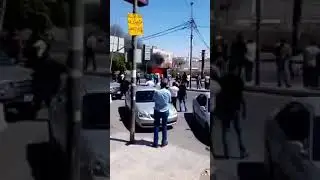 Fire in Street and people trying to help