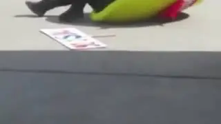 Man in mascot struggling to get up