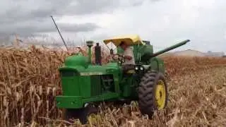 John Deere 4010 LP picking corn with 42 combine